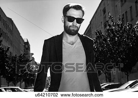 Stock Image - Portrait of man wearing blazer and sunglasses, Berlin, Germany. Fotosearch