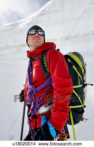 Picture - Portrait of man with mountaineering equipment looking away. Fotosearch