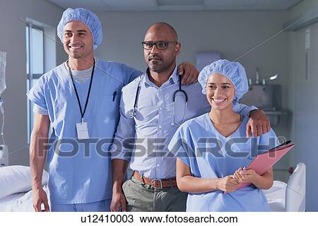 Portrait of mature male doctor and medical team in hospital ward View Large Photo Image Stock Image - Portrait of mature male doctor and medical team in hospital ward. Fotosearch