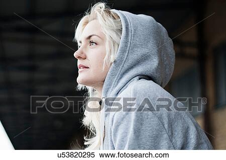 Portrait of mid adult female runner in grey hoody View Large Photo Image Stock Photography - Portrait of mid adult female runner in grey hoody. Fotosearch