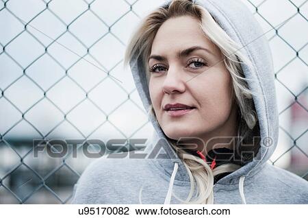 Portrait of mid adult runner by wire fence View Large Photo Image Stock Image - Portrait of mid adult runner by wire fence. Fotosearch