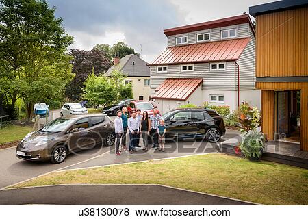 Portrait of people in neighbourhood with electric cars View Large Photo Image Stock Photo - Portrait of people in neighbourhood with electric cars. Fotosearch