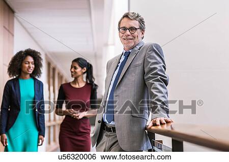 Stock Photograph - Portrait of senior businessman on office balcony. Fotosearch