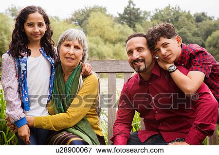 Stock Photo - Portrait of three generation family, outdoors. Fotosearch