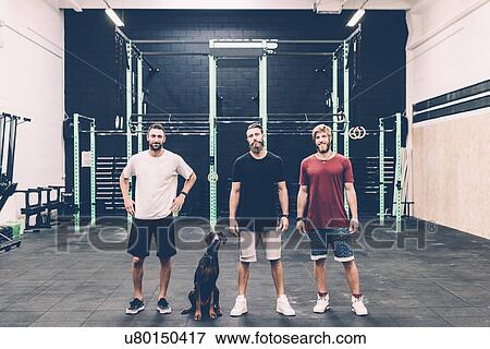 Portrait of three male cross trainers and dog in gym View Large Photo Image Stock Photo - Portrait of three male cross trainers and dog in gym. Fotosearch
