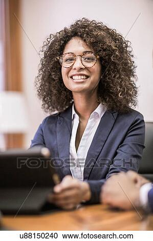 Portrait of young businesswoman at boardroom table View Large Photo Image Stock Image - Portrait of young businesswoman at boardroom table. Fotosearch