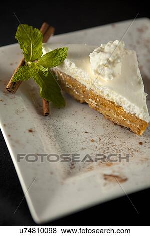 Stock Photo - Pumpkin pie with cinnamon on white plate. Fotosearch