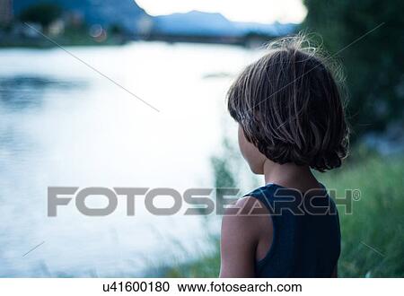 Rear view of boy by river looking away View Large Photo Image Stock Image - Rear view of boy by river looking away. Fotosearch