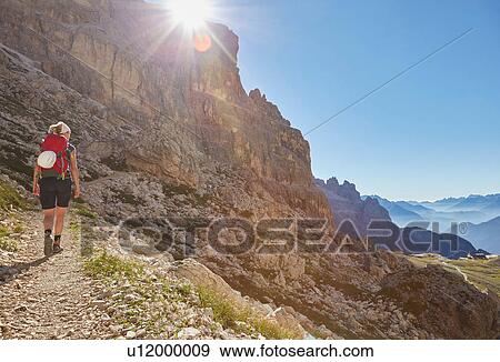 Rear view of female hiker hiking up Dolomites, Sexten, South Tyrol, Italy View Large Photo Image Stock Photo - Rear view of female hiker hiking up Dolomites, Sexten, South Tyrol, Italy. Fotosearch