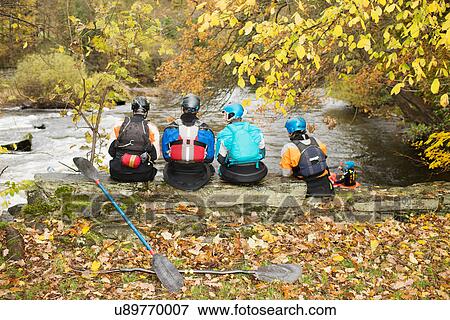 Rear view of kayakers looking out from river bank wall, River Dee, Llangollen, North Wales View Large Photo Image Stock Photo - Rear view of kayakers looking out from river bank wall, River Dee, Llangollen, North Wales. Fotosearch