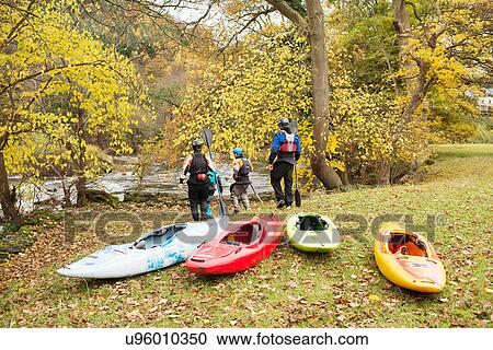 Rear view of kayakers walking down river bank, River Dee, Llangollen, North Wales View Large Photo Image Stock Image - Rear view of kayakers walking down river bank, River Dee, Llangollen, North Wales. Fotosearch