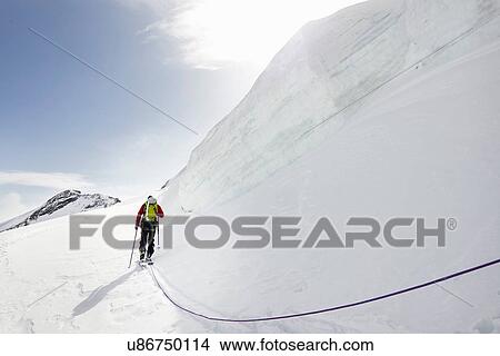 Rear view of mountaineer ski touring on snow-covered mountain, Saas Fee, Switzerland View Large Photo Image Picture - Rear view of mountaineer ski touring on snow-covered mountain, Saas Fee, Switzerland. Fotosearch