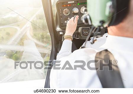 Rear view of pilot in cockpit of aircraft in flight View Large Photo Image Stock Image - Rear view of pilot in cockpit of aircraft in flight. Fotosearch