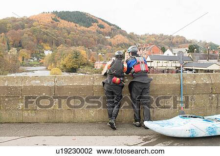Rear view of two kayakers looking out from bridge on River Dee, Llangollen, North Wales View Large Photo Image Stock Image - Rear view of two kayakers looking out from bridge on River Dee, Llangollen, North Wales. Fotosearch
