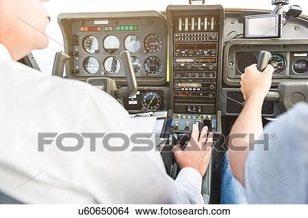 Rear view of two men flying aircraft View Large Photo Image Picture - Rear view of two men flying aircraft. Fotosearch