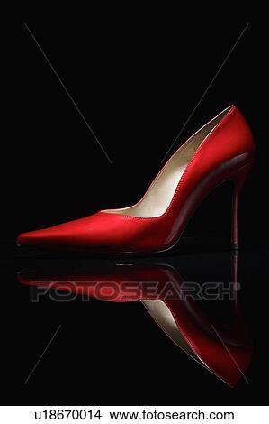 Picture - Red shoe against black background. Fotosearch
