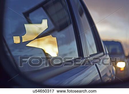 Stock Photo - Reflections of city traffic in car's window. Fotosearch
