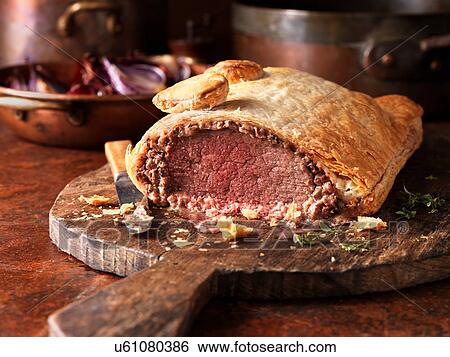 Roast beef wellington, red onions in background, fresh thyme View Large Photo Image Stock Photograph - Roast beef wellington, red onions in background, fresh thyme. Fotosearch