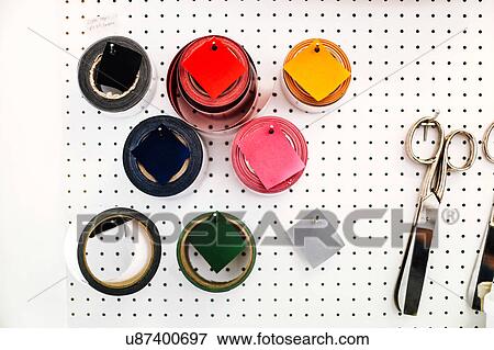 Rolls of coloured tape and scissors on wall in print workshop View Large Photo Image Stock Photo - Rolls of coloured tape and scissors on wall in print workshop. Fotosearch