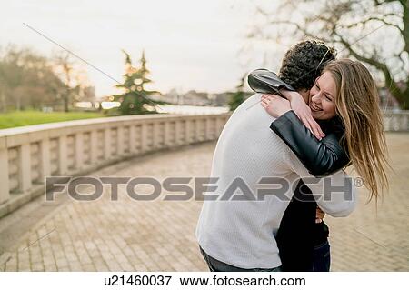 Stock Photo - Romantic couple hugging in Battersea Park, London, UK. Fotosearch