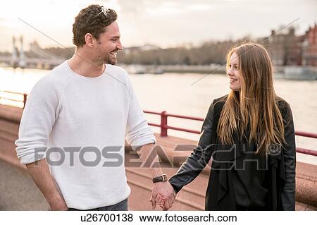 Romantic couple strolling on waterfront, Battersea Park, London, UK View Large Photo Image Stock Photo - Romantic couple strolling on waterfront, Battersea Park, London, UK. Fotosearch