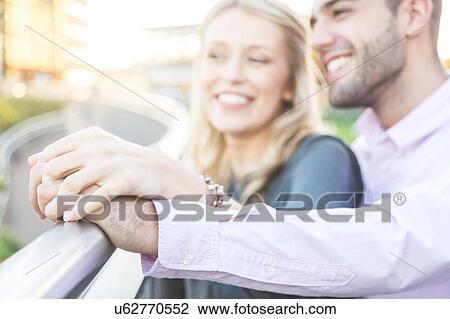Stock Image - Romantic young couple hand on hand, Regent's Canal, London, UK. Fotosearch