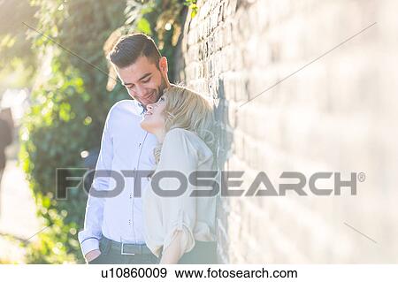 Romantic young couple leaning against brick wall at Regent's Canal, London, UK View Large Photo Image Stock Photo - Romantic young couple leaning against brick wall at Regent's Canal, London, UK. Fotosearch