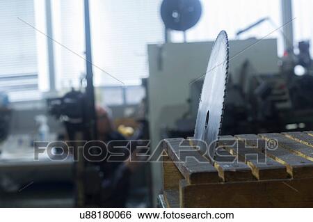Rotary blade in holder, man working in background View Large Photo Image Stock Photograph - Rotary blade in holder, man working in background. Fotosearch