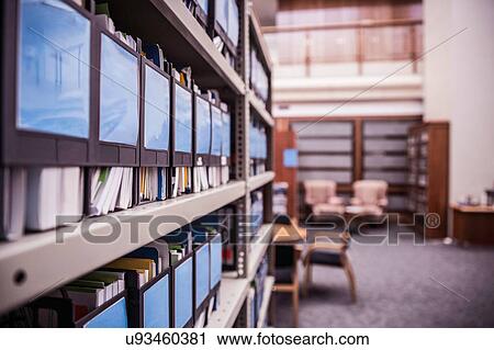 Stock Image - Rows of office shelves with files and paperwork. Fotosearch