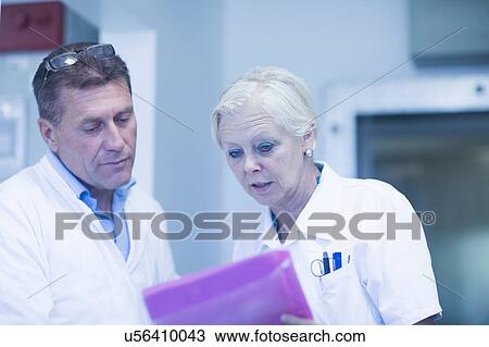 Scientists reading test results in laboratory View Large Photo Image Stock Image - Scientists reading test results in laboratory. Fotosearch