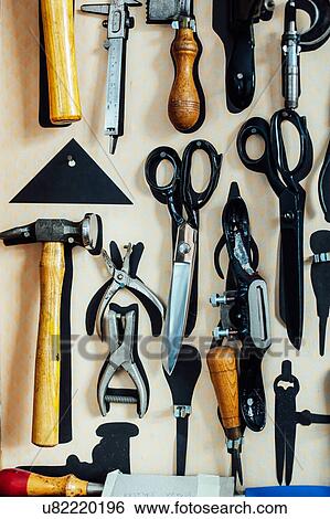 Scissors and tools hanging on wall in arts studio View Large Photo Image Stock Photograph - Scissors and tools hanging on wall in arts studio. Fotosearch