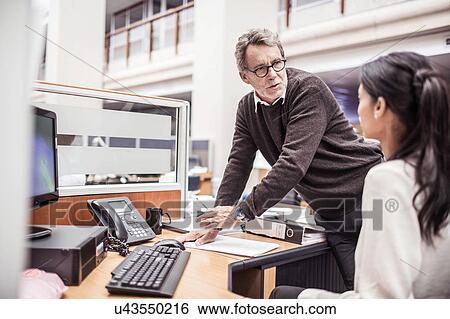 Senior businessman explaining to businesswoman in office View Large Photo Image Stock Photograph - Senior businessman explaining to businesswoman in office. Fotosearch
