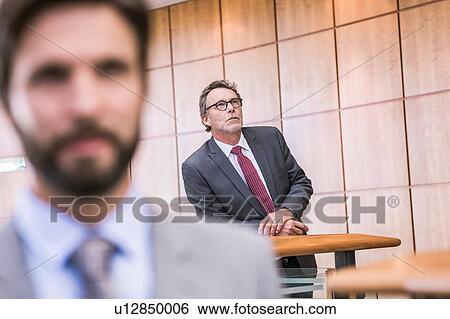 Stock Photograph - Senior businessman waiting on office balcony. Fotosearch