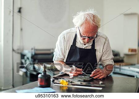 Senior craftsman working on letterpress in print workshop View Large Photo Image Stock Image - Senior craftsman working on letterpress in print workshop. Fotosearch