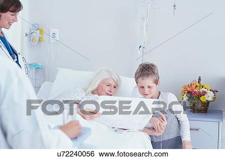 Senior female patient in hospital bed looking at grandson's drawing View Large Photo Image Stock Photograph - Senior female patient in hospital bed looking at grandson's drawing. Fotosearch