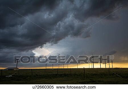 Stock Photography - Severe storms threaten near wind turbines at sunset, south of Dumas, Texas. Fotosearch