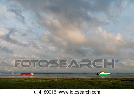 Ships sailing to and from Antwerp harbour. Nuclear power plant in the background, Rilland, Zeeland, Netherlands View Large Photo Image Stock Photograph - Ships sailing to and from Antwerp harbour. Nuclear power plant in the background, Rilland, Zeeland, Netherlands. Fotosearch