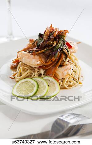 Shrimp and pasta on white plate View Large Photo Image Stock Photo - Shrimp and pasta on white plate. Fotosearch