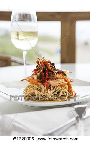 Stock Photography - Shrimp and pasta on white plate. Fotosearch