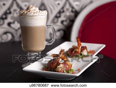 Shrimps with bacon on plates and cocktail in glass View Large Photo Image Stock Photo - Shrimps with bacon on plates and cocktail in glass. Fotosearch