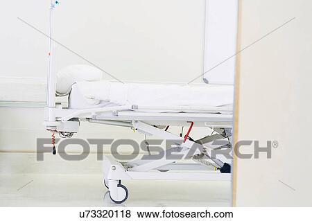 Stock Photo - Side view of empty hospital bed in ward. Fotosearch