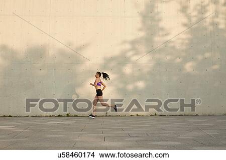 Side view of woman jogging View Large Photo Image Picture - Side view of woman jogging. Fotosearch