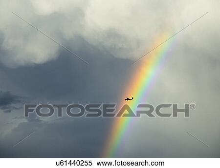 Silhouette of small plane flying through rainbow View Large Photo Image Stock Photography - Silhouette of small plane flying through rainbow. Fotosearch
