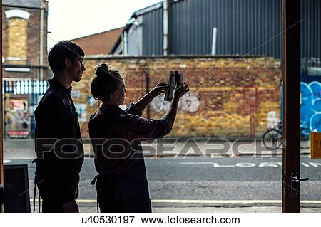 Silhouette of young craftsman and craftswoman holding up work View Large Photo Image Stock Photo - Silhouette of young craftsman and craftswoman holding up work. Fotosearch