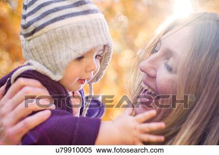 Smiling mother holding baby girl View Large Photo Image Stock Photography - Smiling mother holding baby girl. Fotosearch