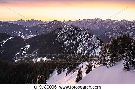 Stock Photograph - Snow-covered mountain landscape at sunrise, Teufelstattkopf mountain, Oberammergau, Bavaria, Germany. Fotosearch