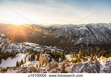 Stock Photography - Snow-covered mountain landscape at sunrise, Teufelstattkopf mountain, Oberammergau, Bavaria, Germany. Fotosearch