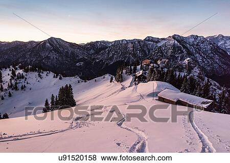 Stock Photo - Snow tracks on Teufelstattkopf mountain at dawn, Oberammergau, Bavaria, Germany. Fotosearch