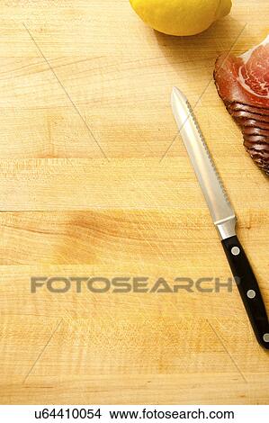Spoon, lemon and slices of meat on cutting board View Large Photo Image Picture - Spoon, lemon and slices of meat on cutting board. Fotosearch