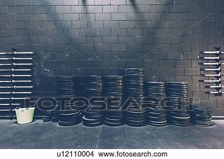Stacked rows of barbell weights in black gym View Large Photo Image Picture - Stacked rows of barbell weights in black gym. Fotosearch